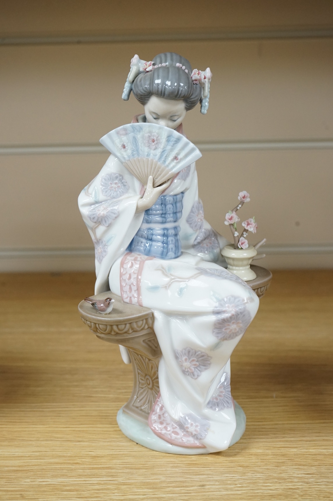 Three Lladro models of seated Geisha. Tallest 23cm
